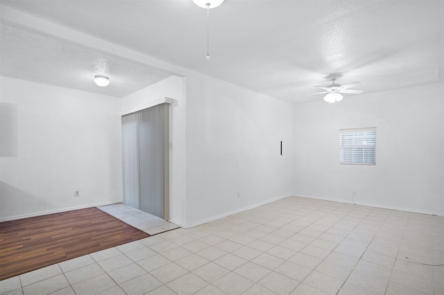 736 Lee St, Mesquite, TX 75149 - empty room featuring a textured ceiling, a ceiling fan, light tile patterned flooring, and baseboards