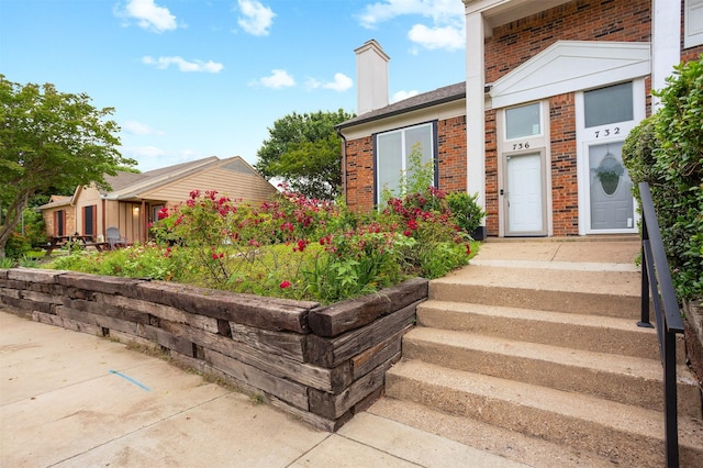 736 Lee St, Mesquite, TX 75149 - view of exterior entry with brick siding and a chimney