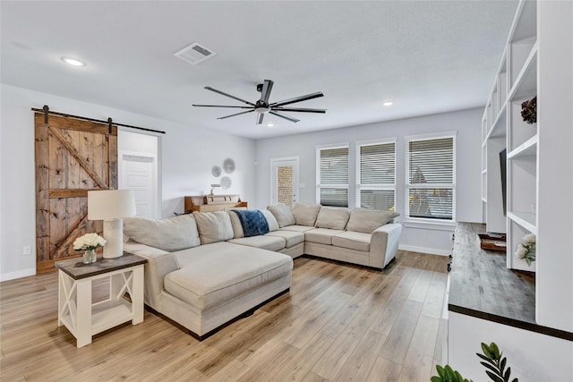 14521 Home Trl, Fort Worth, TX 76262 - living area with a barn door, a ceiling fan, baseboards, light wood-type flooring, and recessed lighting