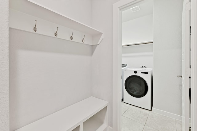 14521 Home Trl, Fort Worth, TX 76262 - laundry area with washer / dryer and light tile patterned flooring
