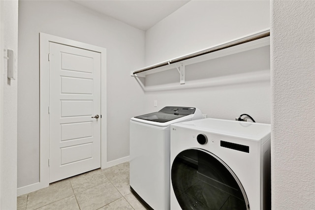 14521 Home Trl, Fort Worth, TX 76262 - washroom featuring separate washer and dryer, baseboards, and light tile patterned floors