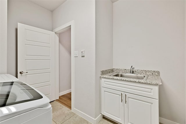 14521 Home Trl, Fort Worth, TX 76262 - laundry room featuring a sink, baseboards, and light tile patterned floors