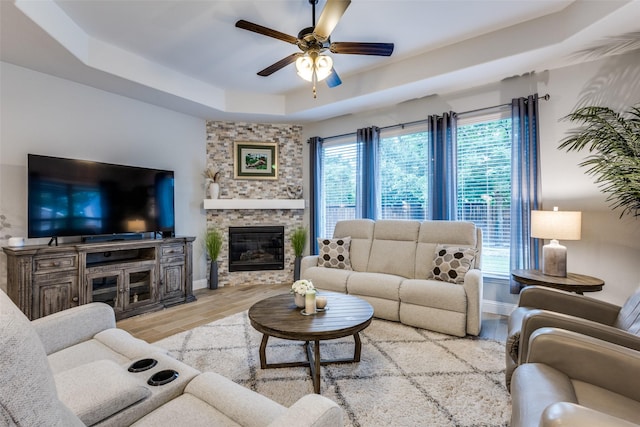 1417 Madrid Falls Dr, Mckinney, TX 75071 - living room with wood finished floors, a tray ceiling, plenty of natural light, and ceiling fan
