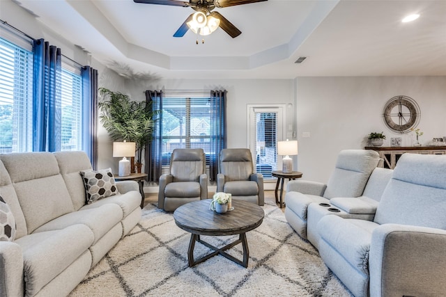 1417 Madrid Falls Dr, Mckinney, TX 75071 - living room with ceiling fan, plenty of natural light, a raised ceiling, and baseboards