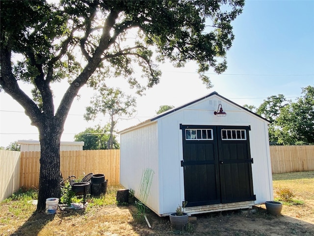 view of shed with a fenced backyard