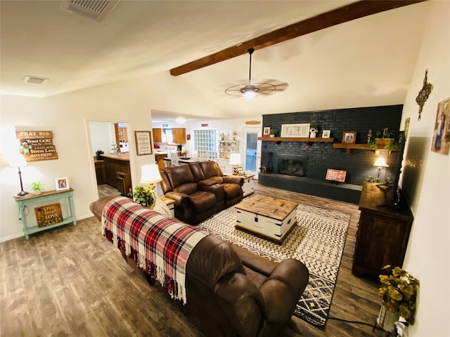 living area with wood finished floors, a ceiling fan, a brick fireplace, and baseboards