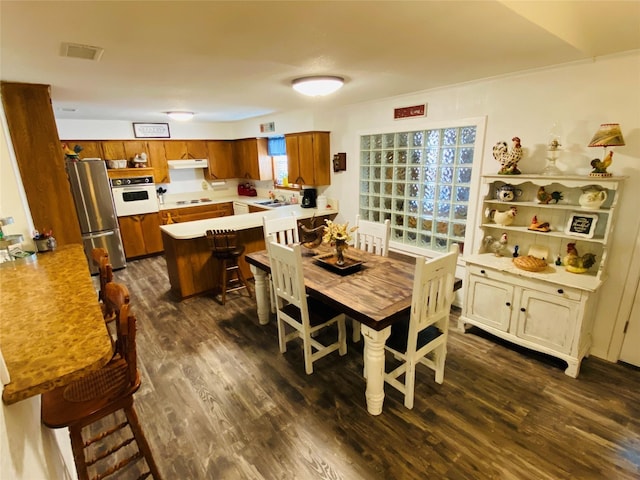 dining area with dark wood-style flooring