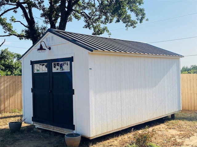 view of shed with fence