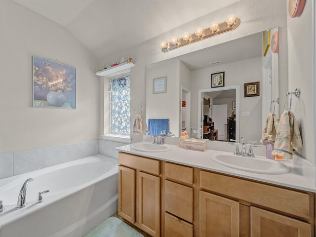2400 Briarhurst Ct, Denton, TX 76207 - full bathroom with double vanity, a garden tub, and vaulted ceiling