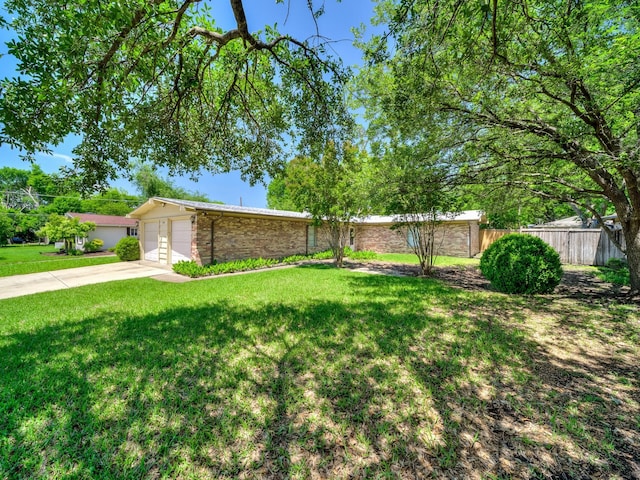 744 Greenhaven Dr, Richardson, TX 75080 - mid-century modern home featuring a garage and concrete driveway