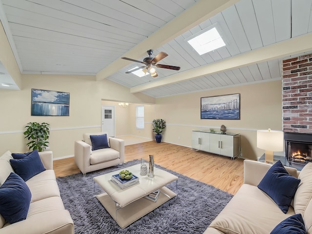 744 Greenhaven Dr, Richardson, TX 75080 - living room featuring wood finished floors, a fireplace, a ceiling fan, and baseboards