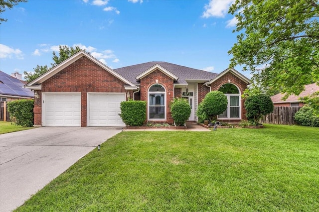 view of front facade with brick siding, driveway, and a garage