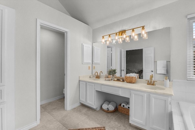 bathroom featuring vaulted ceiling, toilet, double vanity, tile patterned flooring, and tiled tub