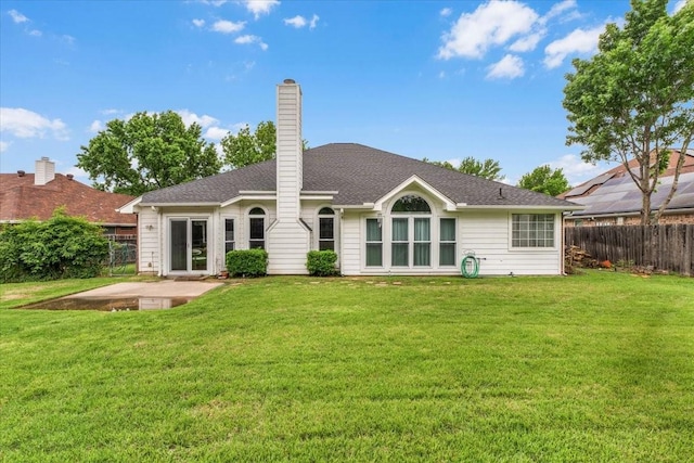 rear view of property with a patio area and a chimney