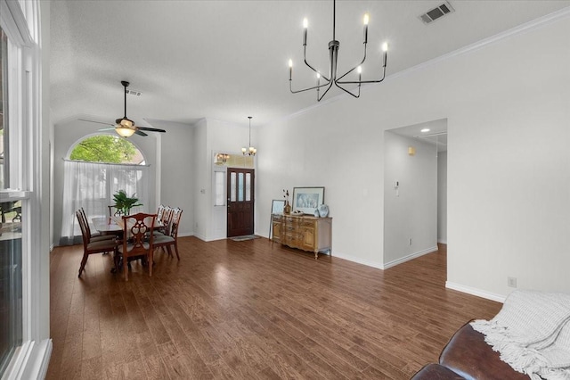 dining area featuring a chandelier, wood finished floors, a ceiling fan, crown molding, and baseboards