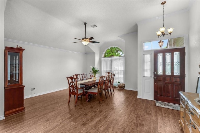 dining room featuring a chandelier, crown molding, wood finished floors, ceiling fan, and baseboards