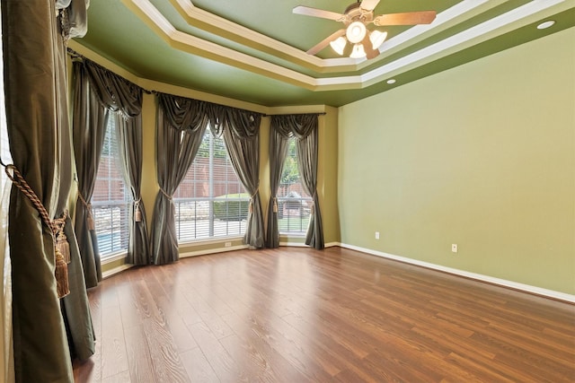 2609 Green Oak Dr, Carrollton, TX 75010 - unfurnished room with crown molding, ceiling fan, baseboards, a raised ceiling, and wood finished floors