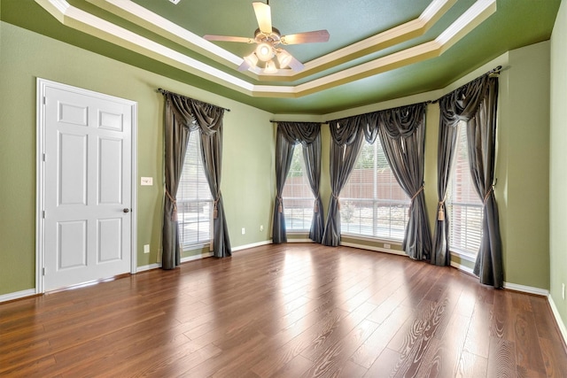 2609 Green Oak Dr, Carrollton, TX 75010 - unfurnished room with a tray ceiling, ornamental molding, ceiling fan, plenty of natural light, and wood finished floors