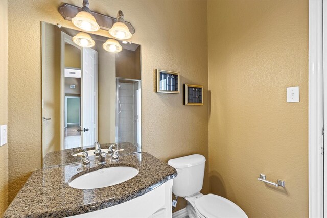 2609 Green Oak Dr, Carrollton, TX 75010 - bathroom with a textured wall, toilet, and vanity