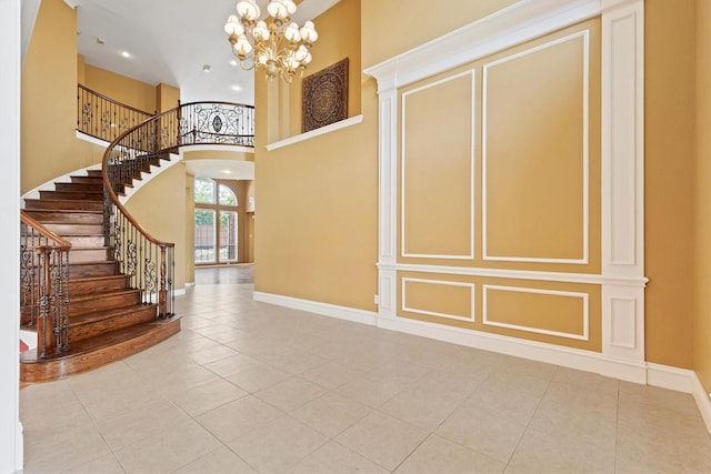 2609 Green Oak Dr, Carrollton, TX 75010 - tiled foyer featuring baseboards, a high ceiling, a chandelier, stairway, and recessed lighting