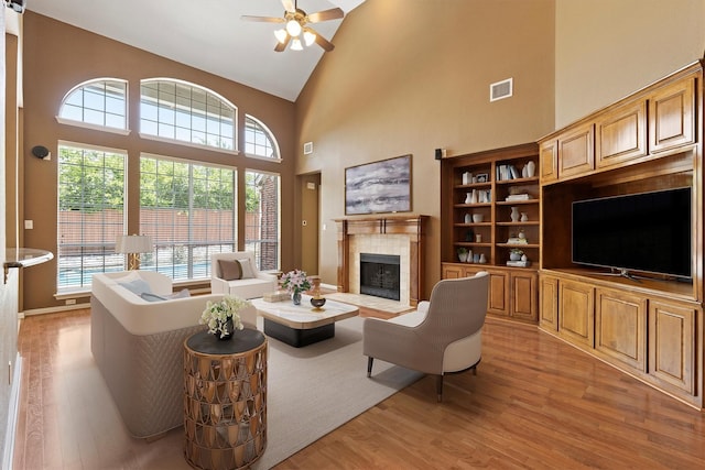 2609 Green Oak Dr, Carrollton, TX 75010 - living area with high vaulted ceiling, light wood-type flooring, ceiling fan, and plenty of natural light