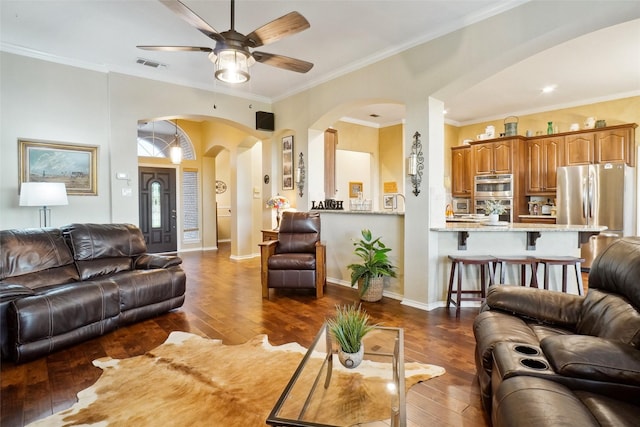 7300 Bishop Ct, Fort Worth, TX 76179 - living room featuring arched walkways, a ceiling fan, dark wood-type flooring, ornamental molding, and baseboards
