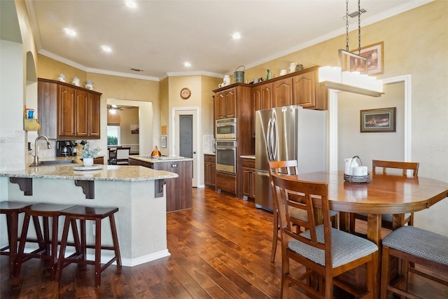 7300 Bishop Ct, Fort Worth, TX 76179 - kitchen featuring stainless steel appliances, a sink, a peninsula, a center island, and dark wood-style floors