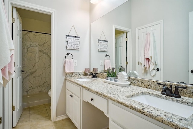7300 Bishop Ct, Fort Worth, TX 76179 - bathroom with a shower stall, double vanity, tile patterned flooring, and toilet