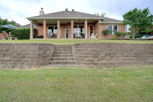 7300 Bishop Ct, Fort Worth, TX 76179 - view of front of property with a chimney, brick siding, a patio, and a front yard