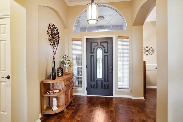 7300 Bishop Ct, Fort Worth, TX 76179 - foyer featuring dark wood-type flooring, baseboards, healthy amount of natural light, ornamental molding, and arched walkways