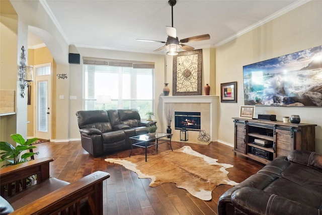7300 Bishop Ct, Fort Worth, TX 76179 - living area featuring hardwood / wood-style flooring, a tile fireplace, crown molding, a ceiling fan, and arched walkways