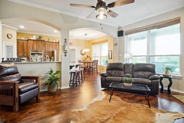 7300 Bishop Ct, Fort Worth, TX 76179 - living room with arched walkways, dark wood-type flooring, plenty of natural light, a ceiling fan, and ornamental molding