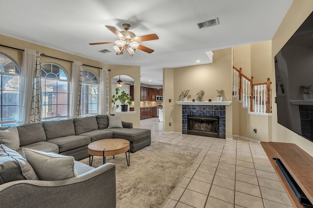 533 Cameron Ln, Allen, TX 75002 - living area featuring ceiling fan, light tile patterned floors, a fireplace, and baseboards