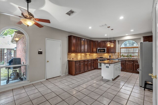 533 Cameron Ln, Allen, TX 75002 - kitchen with appliances with stainless steel finishes, healthy amount of natural light, backsplash, light tile patterned floors, and recessed lighting