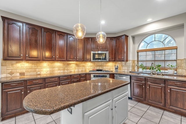 533 Cameron Ln, Allen, TX 75002 - kitchen with a sink, appliances with stainless steel finishes, light tile patterned floors, dark stone countertops, and recessed lighting
