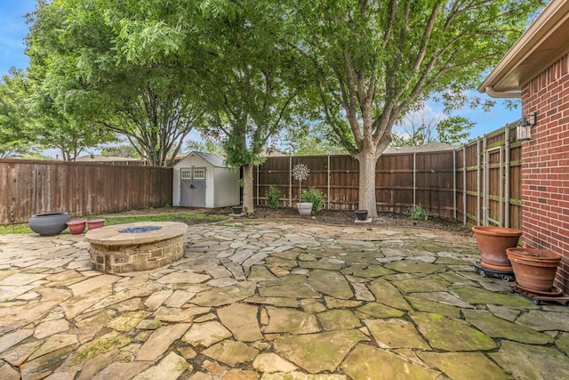 533 Cameron Ln, Allen, TX 75002 - view of patio featuring a shed, a fenced backyard, an outdoor structure, and an outdoor fire pit