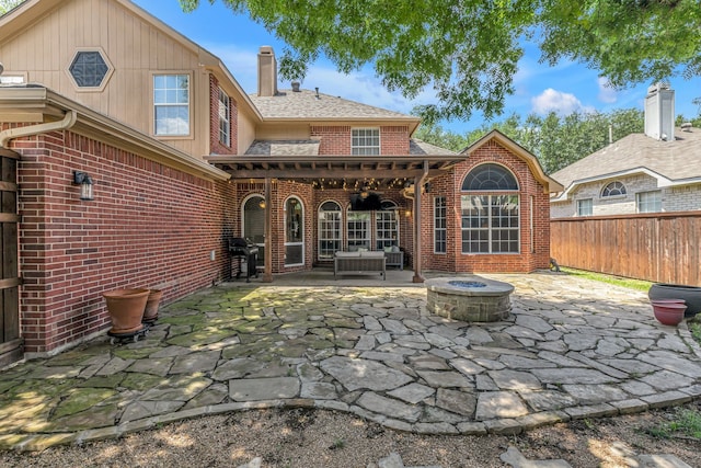 533 Cameron Ln, Allen, TX 75002 - back of house featuring brick siding, a patio area, a chimney, an outdoor fire pit, and fence