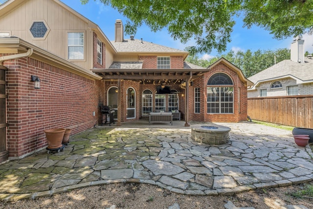 533 Cameron Ln, Allen, TX 75002 - rear view of house featuring brick siding, a patio area, a chimney, a fire pit, and fence