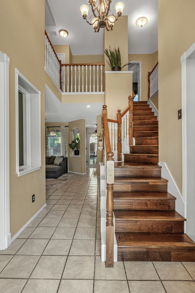 533 Cameron Ln, Allen, TX 75002 - stairway featuring a towering ceiling, tile patterned floors, a chandelier, and baseboards
