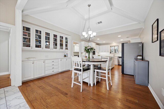 dining space with a chandelier and baseboards