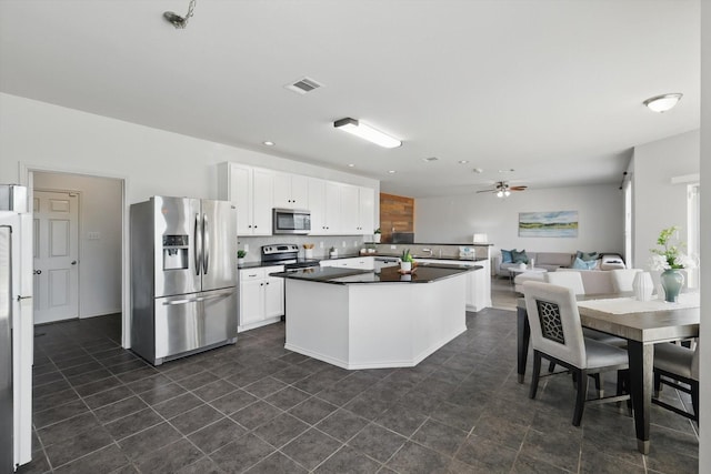 4800 Blue Top Dr, Fort Worth, TX 76179 - kitchen with stainless steel appliances, dark countertops, white cabinetry, a center island, and ceiling fan