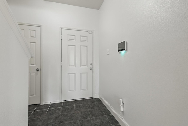 4800 Blue Top Dr, Fort Worth, TX 76179 - hallway with dark tile patterned flooring and baseboards