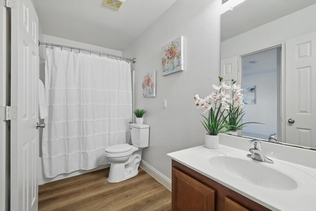 4800 Blue Top Dr, Fort Worth, TX 76179 - bathroom featuring toilet, wood finished floors, baseboards, vanity, and curtained shower