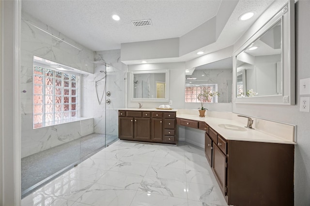 6748 Bastille Dr, Plano, TX 75024 - full bathroom featuring a marble finish shower, marble look tile flooring, recessed lighting, a textured ceiling, and vanity