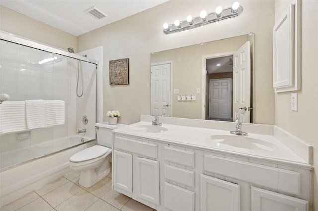 6748 Bastille Dr, Plano, TX 75024 - bathroom featuring tile patterned floors, combined bath / shower with glass door, toilet, and double vanity