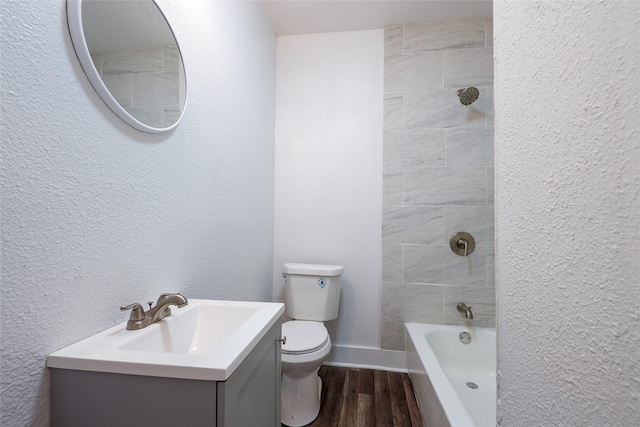 335 N Marsalis Ave, Dallas, TX 75203 - bathroom with toilet, wood finished floors, vanity, washtub / shower combination, and baseboards