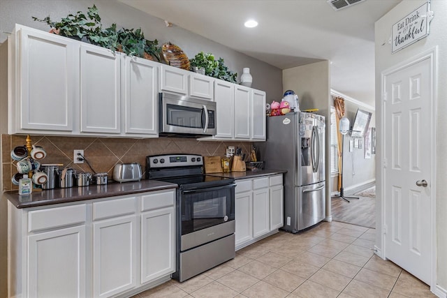 503 Sundrop Dr, Fate, TX 75132 - kitchen with stainless steel appliances, backsplash, dark countertops, white cabinets, and recessed lighting