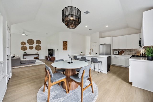 12306 Ark Rd, Frisco, TX 75035 - dining space with light wood finished floors, recessed lighting, vaulted ceiling, and a chandelier