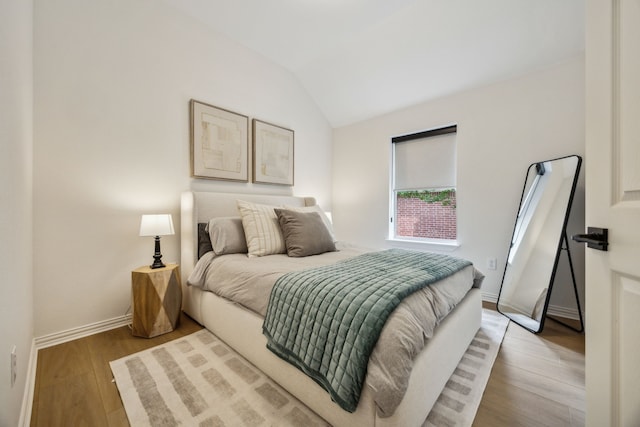 12306 Ark Rd, Frisco, TX 75035 - bedroom with light wood-style floors, baseboards, and lofted ceiling