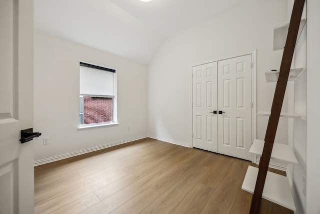 12306 Ark Rd, Frisco, TX 75035 - unfurnished bedroom featuring vaulted ceiling, wood finished floors, and a closet